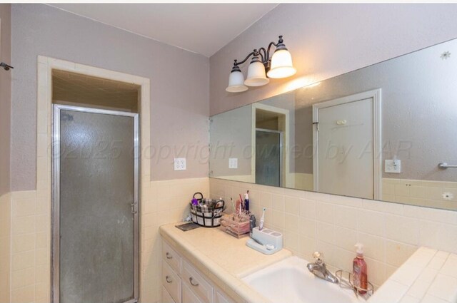 6102 Calumet Rd, Amarillo, TX 79106 - full bath with a stall shower, vanity, and tile walls