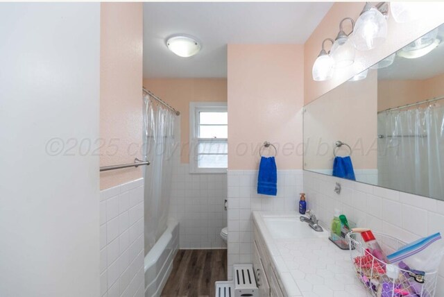 6102 Calumet Rd, Amarillo, TX 79106 - full bath featuring tile walls, vanity, wainscoting, shower / bath combo with shower curtain, and wood finished floors