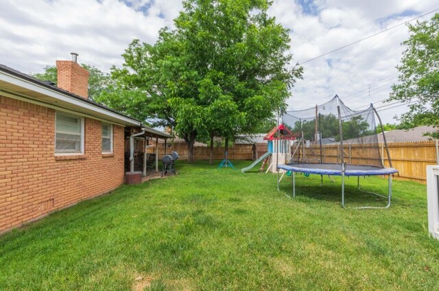 6102 Calumet Rd, Amarillo, TX 79106 - fenced backyard with a trampoline and a playground