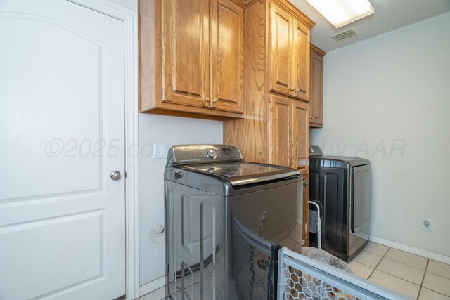 8301 San Antonio Dr, Amarillo, TX 79118 - laundry area with washer and dryer, cabinet space, light tile patterned floors, and baseboards