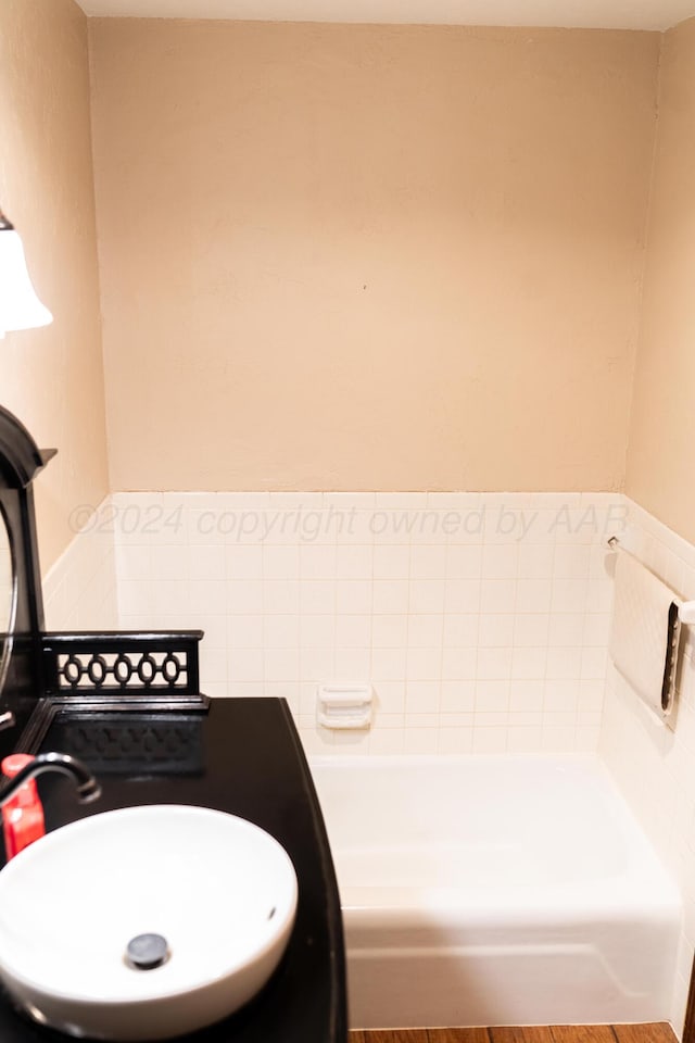 bathroom with a bathing tub and sink