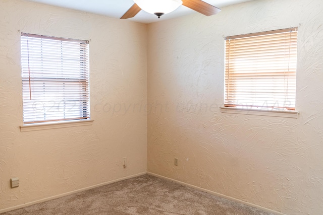 empty room featuring carpet flooring and ceiling fan