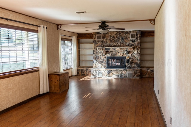 unfurnished living room featuring a fireplace, hardwood / wood-style flooring, ceiling fan, and built in features