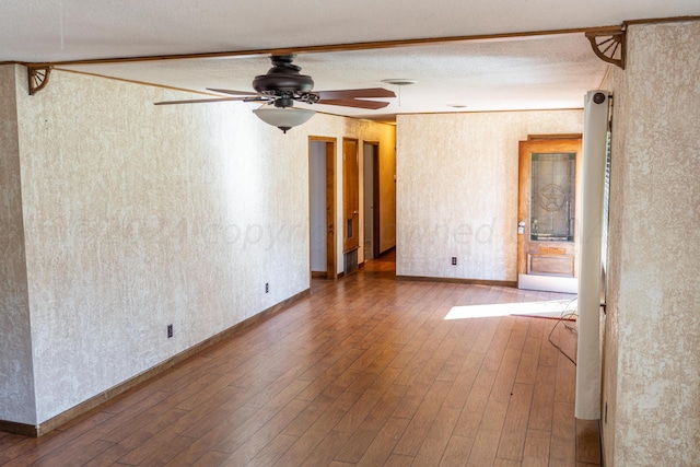 unfurnished room featuring hardwood / wood-style flooring, ceiling fan, and a textured ceiling