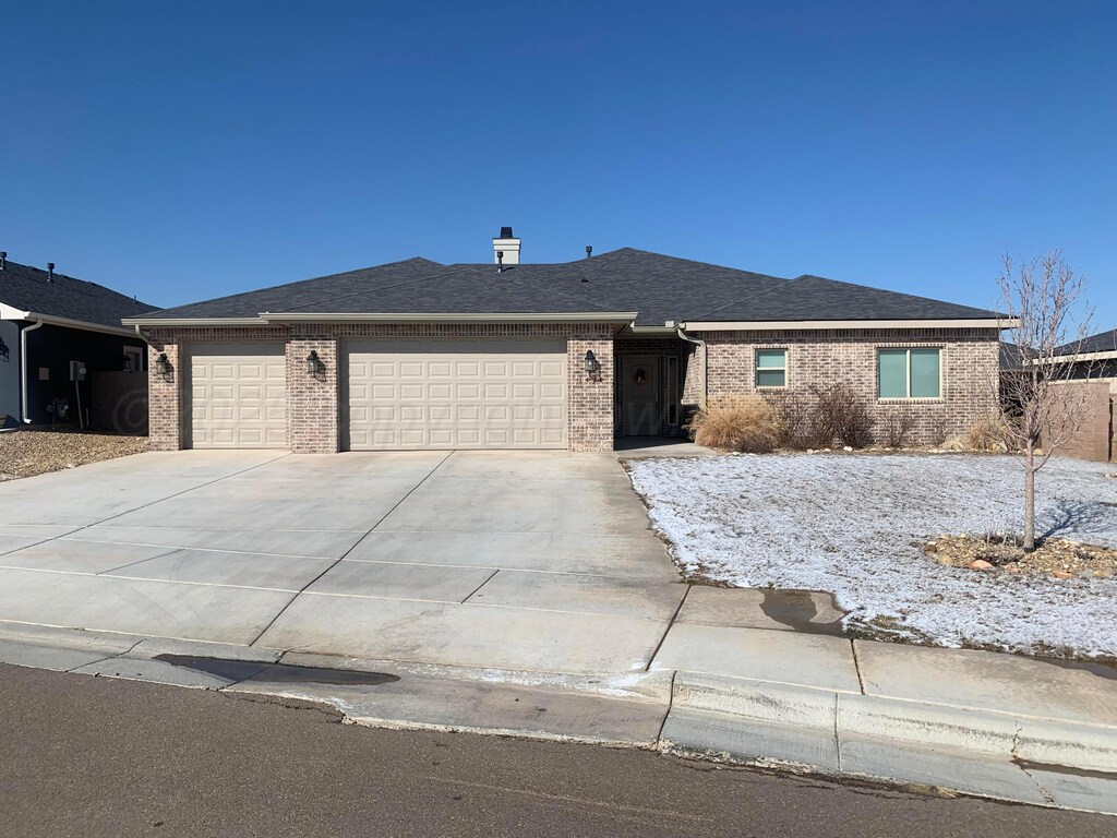 1428 Fume Blvd, Amarillo, TX 79124 - ranch-style home with an attached garage, brick siding, driveway, and roof with shingles