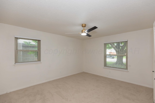 3301 Palmetto Trl, Amarillo, TX 79106 - spare room featuring light colored carpet, a ceiling fan, baseboards, and a textured ceiling