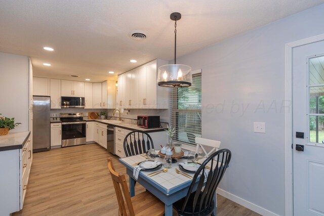 3301 Palmetto Trl, Amarillo, TX 79106 - dining area with light wood-style floors, recessed lighting, a chandelier, and baseboards