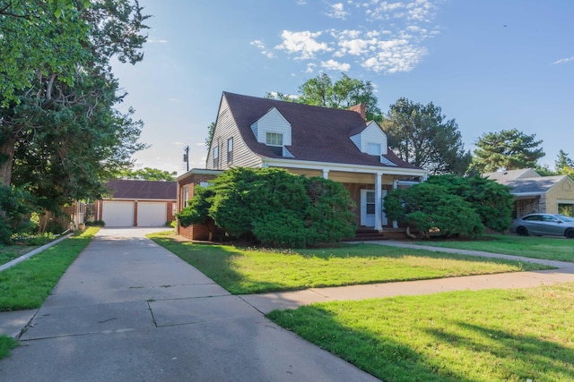 2807 S Harrison St, Amarillo, TX 79109 - cape cod-style house featuring an outbuilding, a front yard, a detached garage, and brick siding