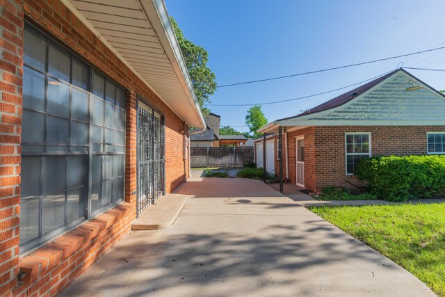 2807 S Harrison St, Amarillo, TX 79109 - view of side of home featuring brick siding and a patio