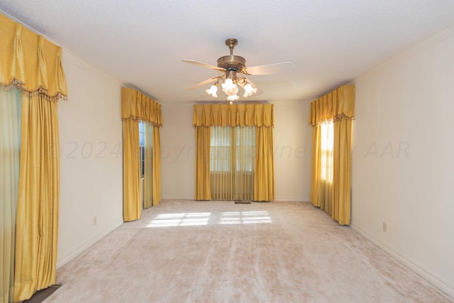 2807 S Harrison St, Amarillo, TX 79109 - empty room with light carpet, a ceiling fan, ornamental molding, a textured ceiling, and baseboards