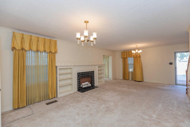 2807 S Harrison St, Amarillo, TX 79109 - unfurnished living room featuring a chandelier, crown molding, a textured ceiling, carpet floors, and a tiled fireplace