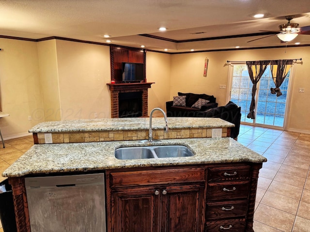 kitchen featuring a brick fireplace, dishwasher, light tile patterned floors, and sink