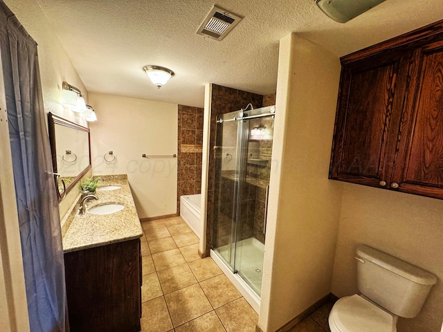 full bathroom featuring plus walk in shower, tile patterned flooring, a textured ceiling, toilet, and vanity