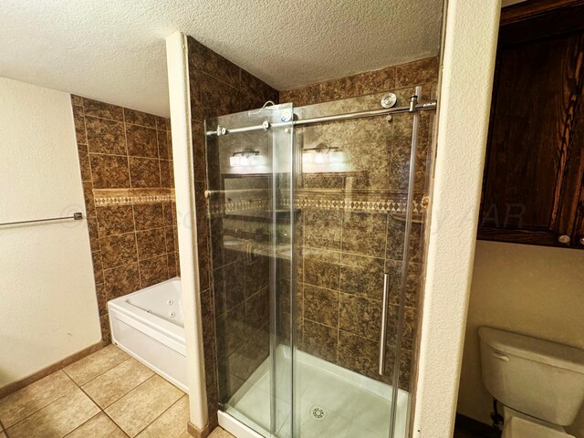 bathroom with tile patterned flooring, shower with separate bathtub, toilet, and a textured ceiling