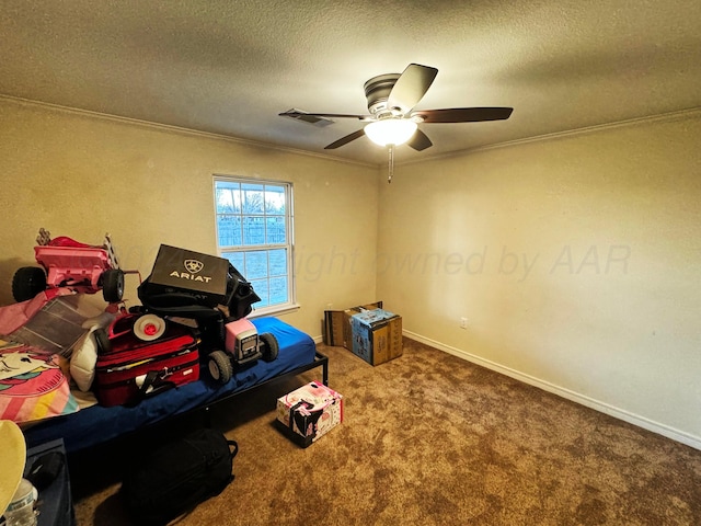 interior space featuring carpet, ceiling fan, ornamental molding, and a textured ceiling