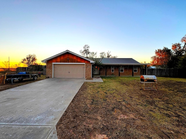 single story home with a yard and a garage