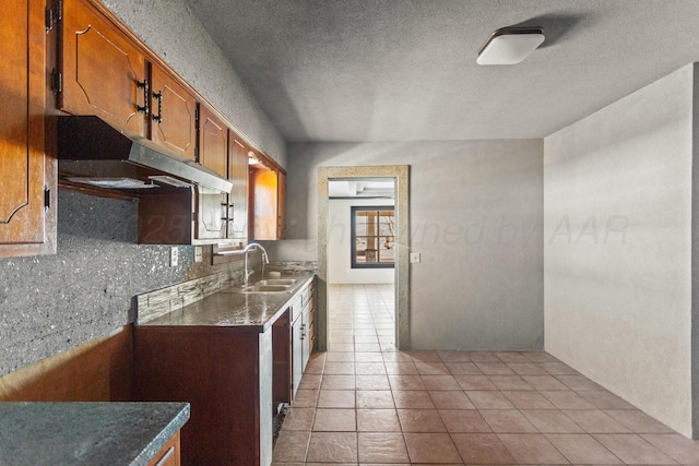 kitchen with light tile patterned floors, tasteful backsplash, and sink