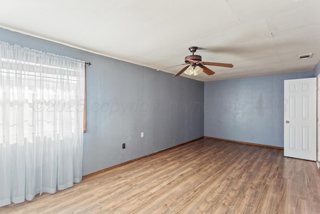 empty room featuring hardwood / wood-style flooring and ceiling fan