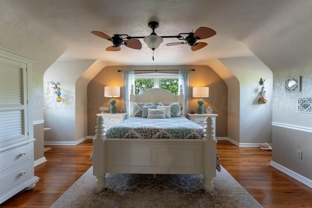 bedroom with a textured ceiling, wood finished floors, ceiling fan, and baseboards