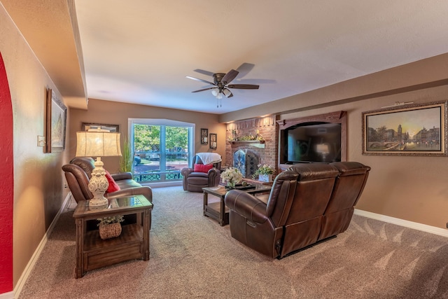 carpeted living area featuring ceiling fan and baseboards