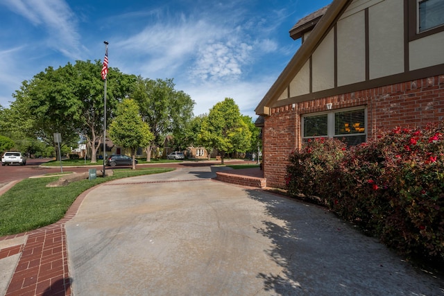 view of property exterior featuring brick siding and stucco siding