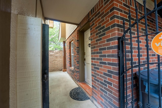 doorway to property with brick siding
