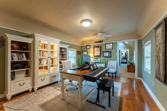 office space with a ceiling fan, hardwood / wood-style flooring, baseboards, lofted ceiling, and a textured ceiling