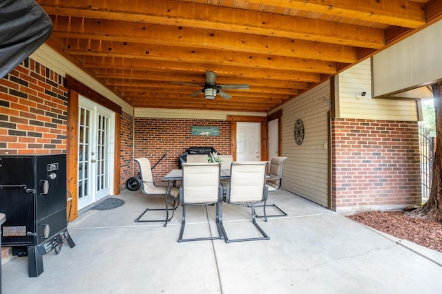 view of patio / terrace with french doors, outdoor dining area, and ceiling fan