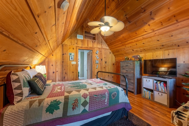 bedroom with vaulted ceiling, wood finished floors, wooden ceiling, and wooden walls