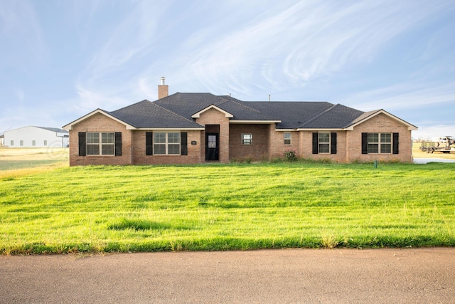 ranch-style home featuring a front yard