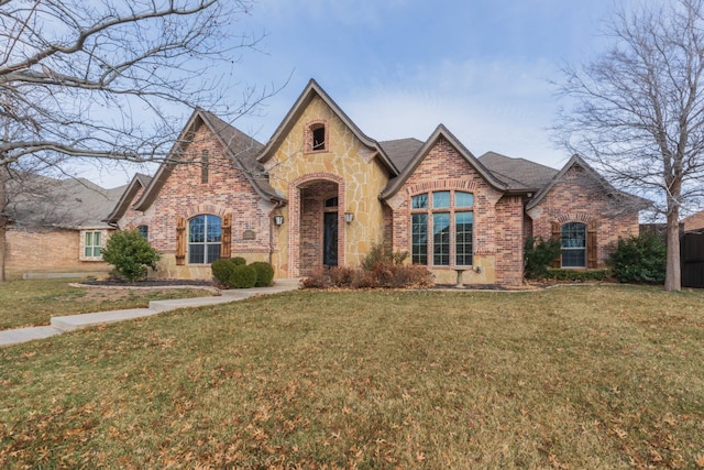 english style home with a front yard