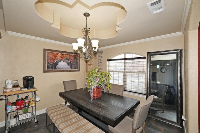 dining room featuring a chandelier, ornamental molding, visible vents, and baseboards