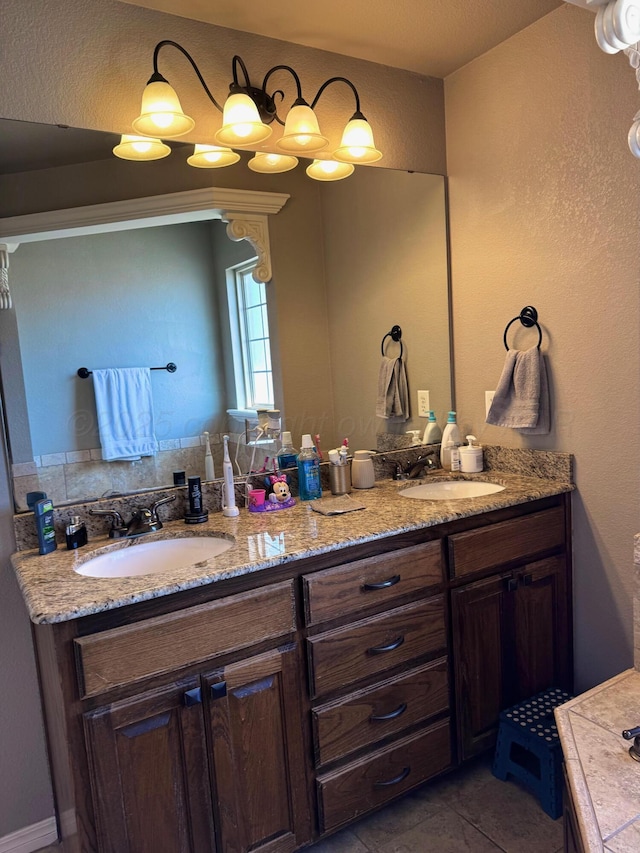 bathroom with double vanity, a sink, and tile patterned floors