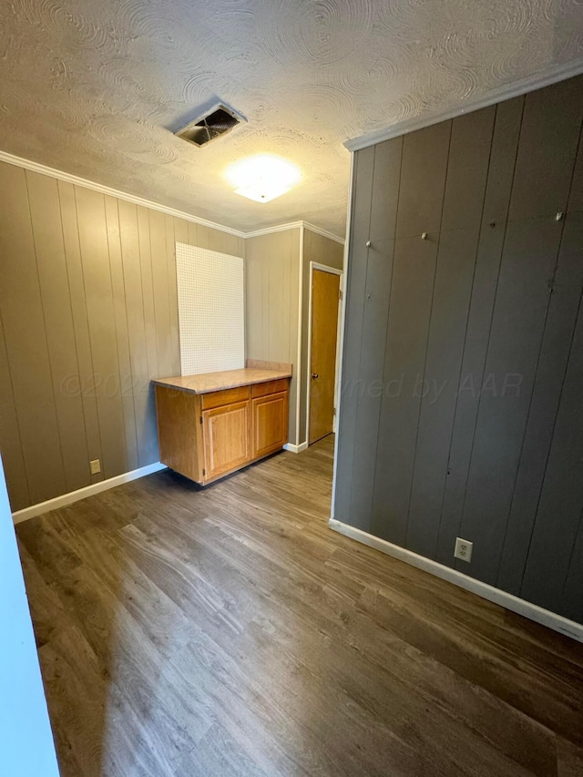 interior space featuring hardwood / wood-style flooring and wood walls