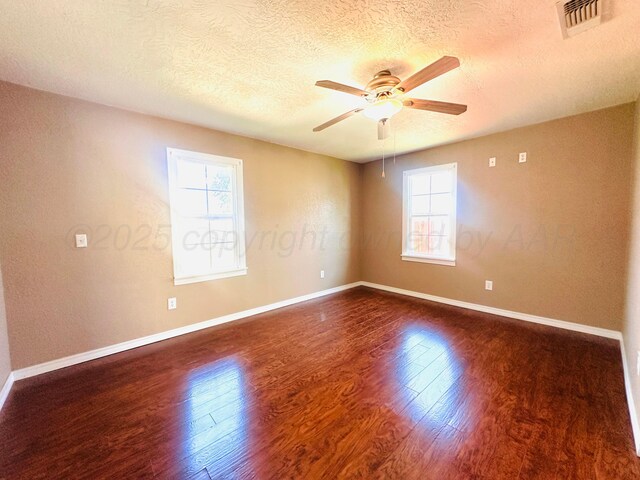 1521 Fox Ave, Dumas, TX 79029 - unfurnished room with a textured ceiling, healthy amount of natural light, a ceiling fan, and wood finished floors