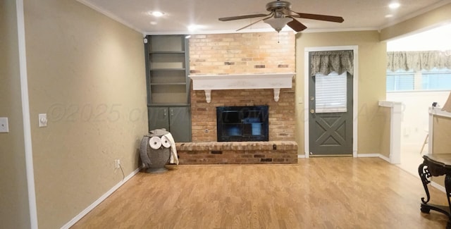 706 Mills Ave, Dumas, TX 79029 - unfurnished living room featuring wood finished floors, crown molding, ceiling fan, a brick fireplace, and recessed lighting