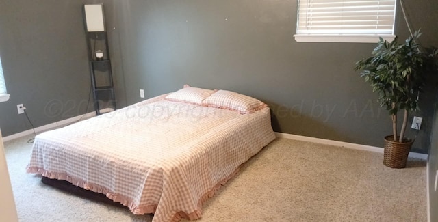 706 Mills Ave, Dumas, TX 79029 - carpeted bedroom with multiple windows