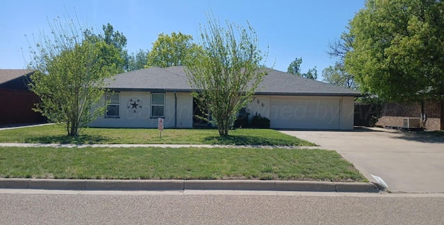 706 Mills Ave, Dumas, TX 79029 - ranch-style house with concrete driveway, an attached garage, and a front lawn