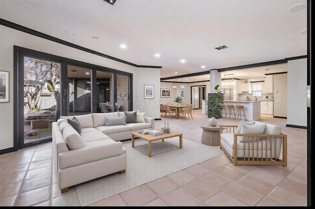 living room featuring ornamental molding and light tile patterned flooring