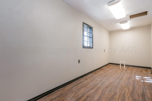 unfurnished room featuring wood-type flooring