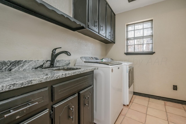 laundry room with washer and dryer, sink, light tile patterned floors, and cabinets