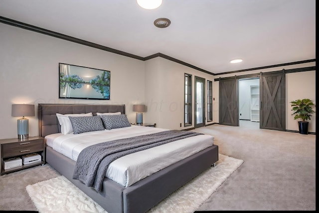 bedroom featuring crown molding, light colored carpet, and a barn door