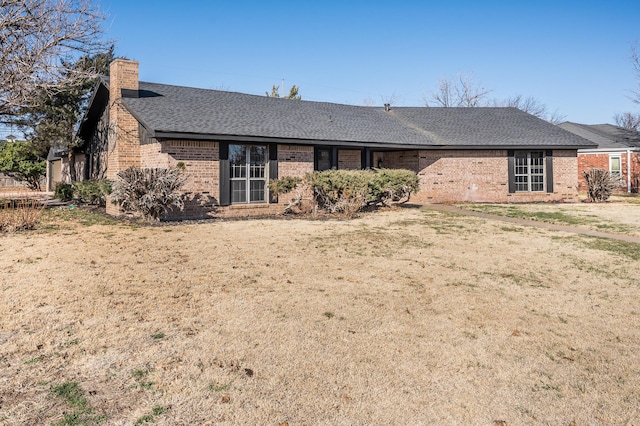 rear view of house with a yard