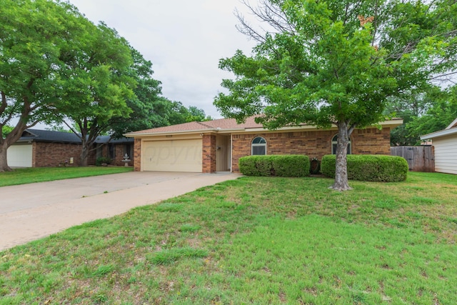 5025 S Fannin St, Amarillo, TX 79110 - ranch-style home featuring brick siding, concrete driveway, and an attached garage