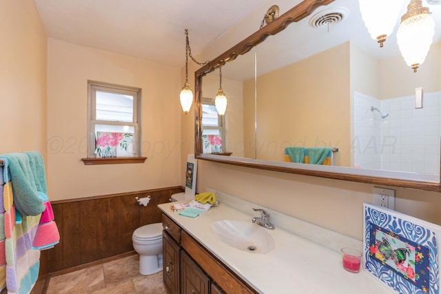 5025 S Fannin St, Amarillo, TX 79110 - bathroom featuring vanity, a shower, and a wainscoted wall