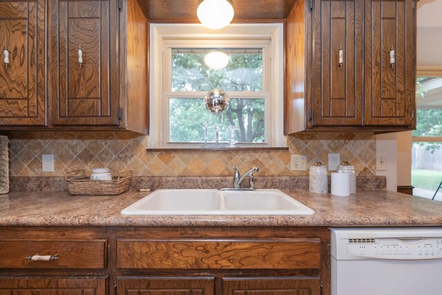 5025 S Fannin St, Amarillo, TX 79110 - kitchen with white dishwasher, backsplash, and light countertops