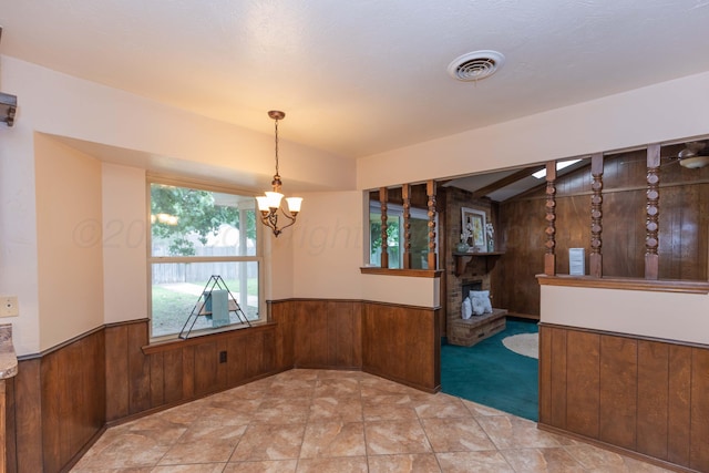 5025 S Fannin St, Amarillo, TX 79110 - unfurnished dining area featuring wooden walls, wainscoting, a chandelier, vaulted ceiling, and carpet floors