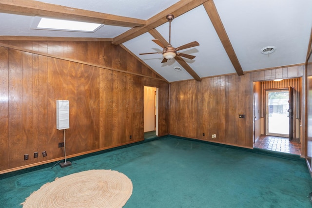 5025 S Fannin St, Amarillo, TX 79110 - unfurnished room with wood walls, carpet floors, ceiling fan, and a skylight