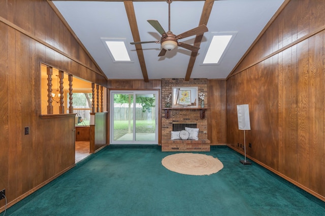 5025 S Fannin St, Amarillo, TX 79110 - unfurnished living room featuring a ceiling fan, lofted ceiling, wood walls, carpet, and a skylight