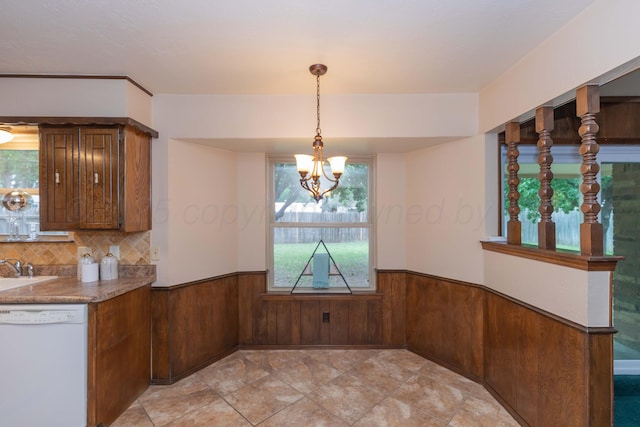 5025 S Fannin St, Amarillo, TX 79110 - unfurnished dining area with a wainscoted wall, a chandelier, and wooden walls
